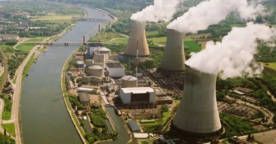 Cooling towers in daytime beside river