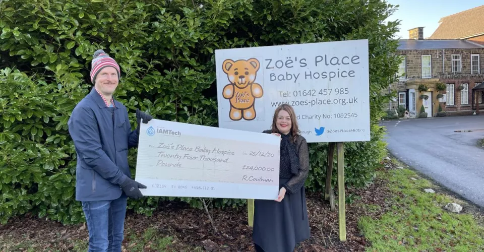 Ross Coulman presenting a cheque to Zoes Place Baby Hospice Charity in Teesside
