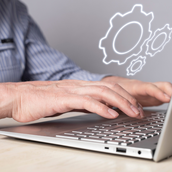 Man on laptop configuring industrial software solution