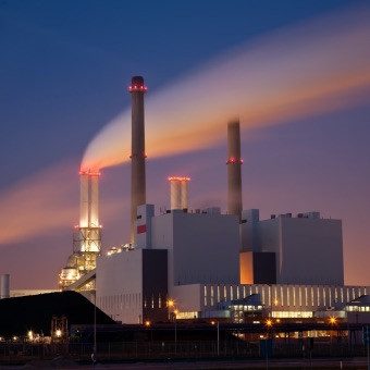 Power plant at night with flames